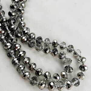 Metallic gray crystal bead necklace with silver tone spacers